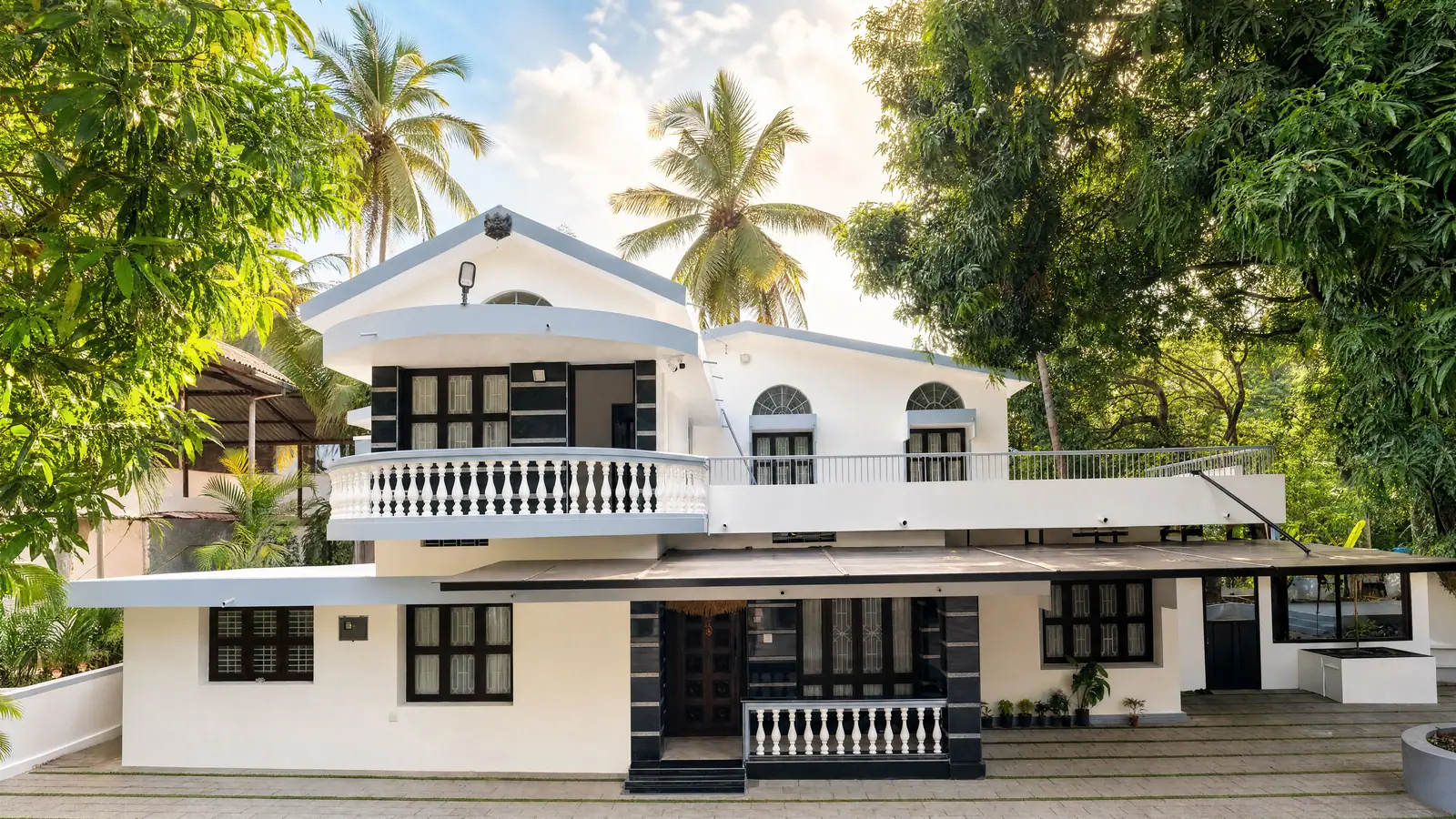 Nestled amidst lush greenery, the heritage architecture of Spanda offers a serene and timeless coastal retreat.