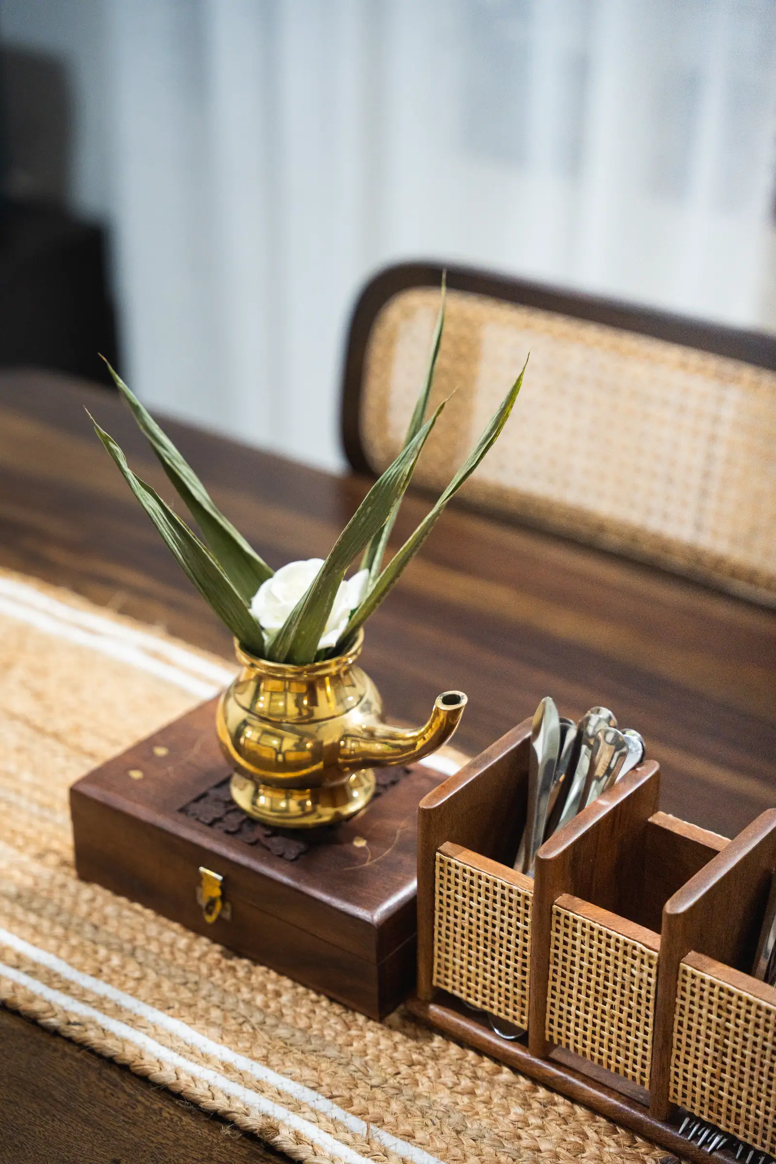 Brass kindi and lamp — a dining-table detail