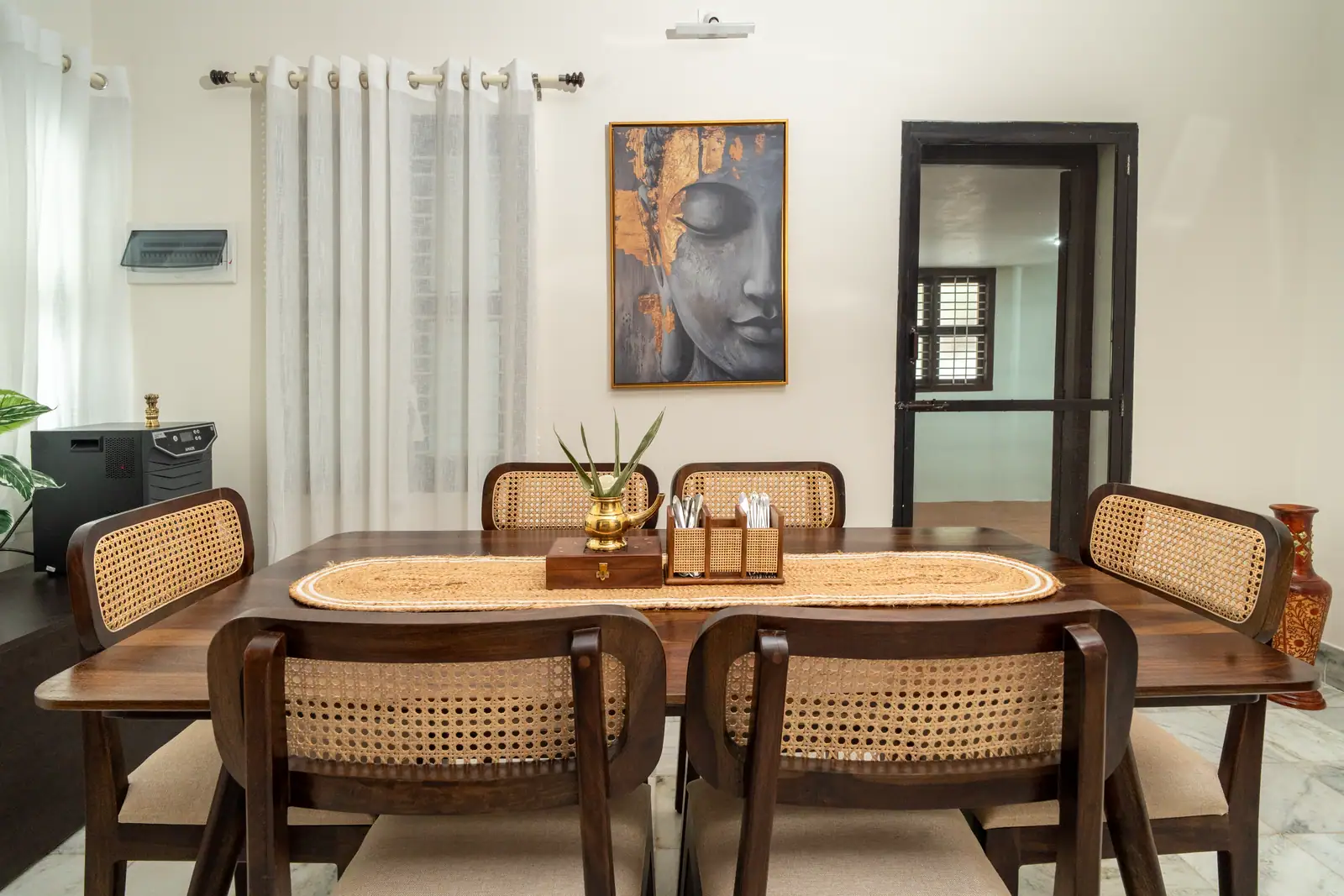 Gather for soulful meals at this elegant wooden dining table, framed by serene, heritage-inspired decor.