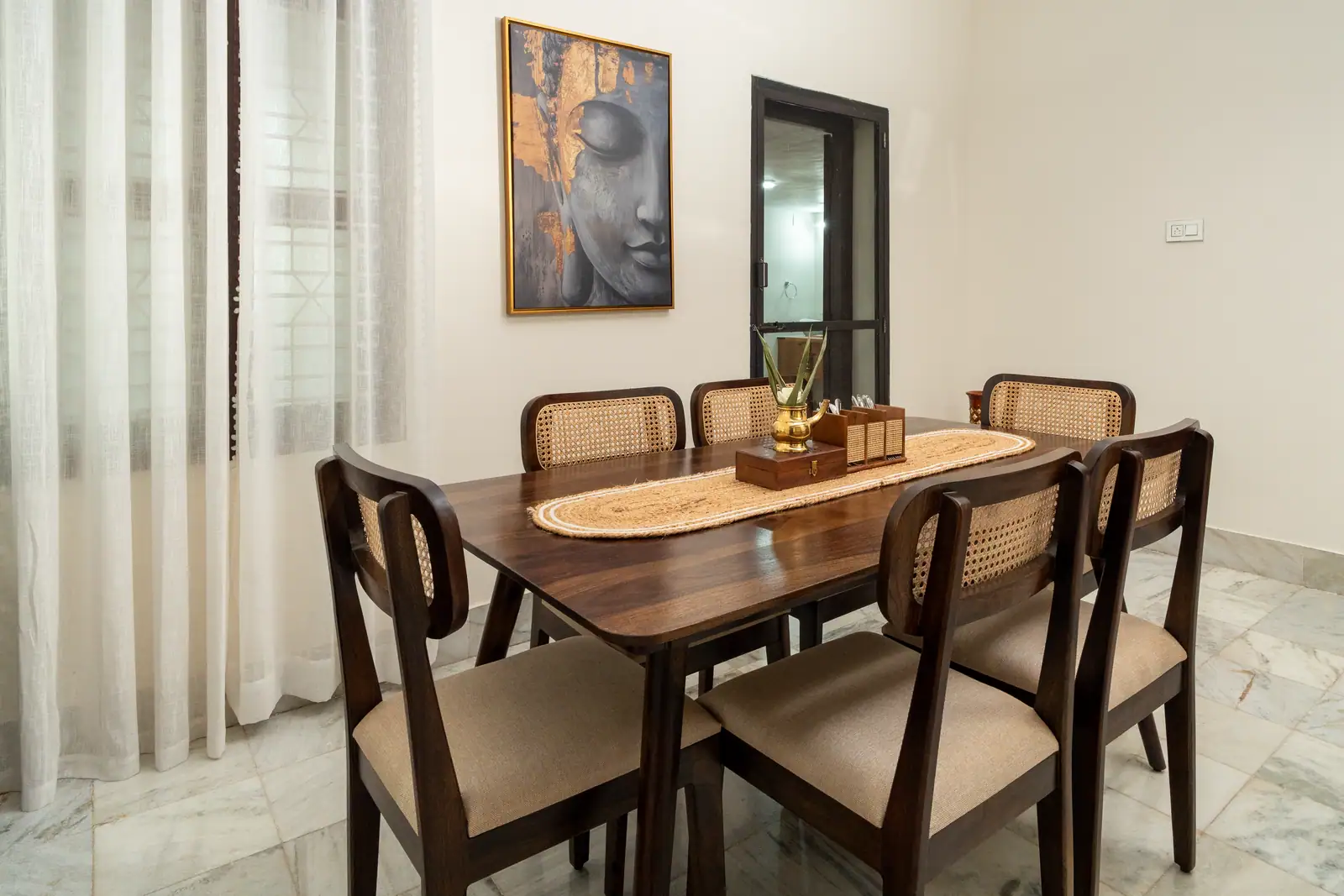 The warm teak dining room at Spanda, set under soft daylight