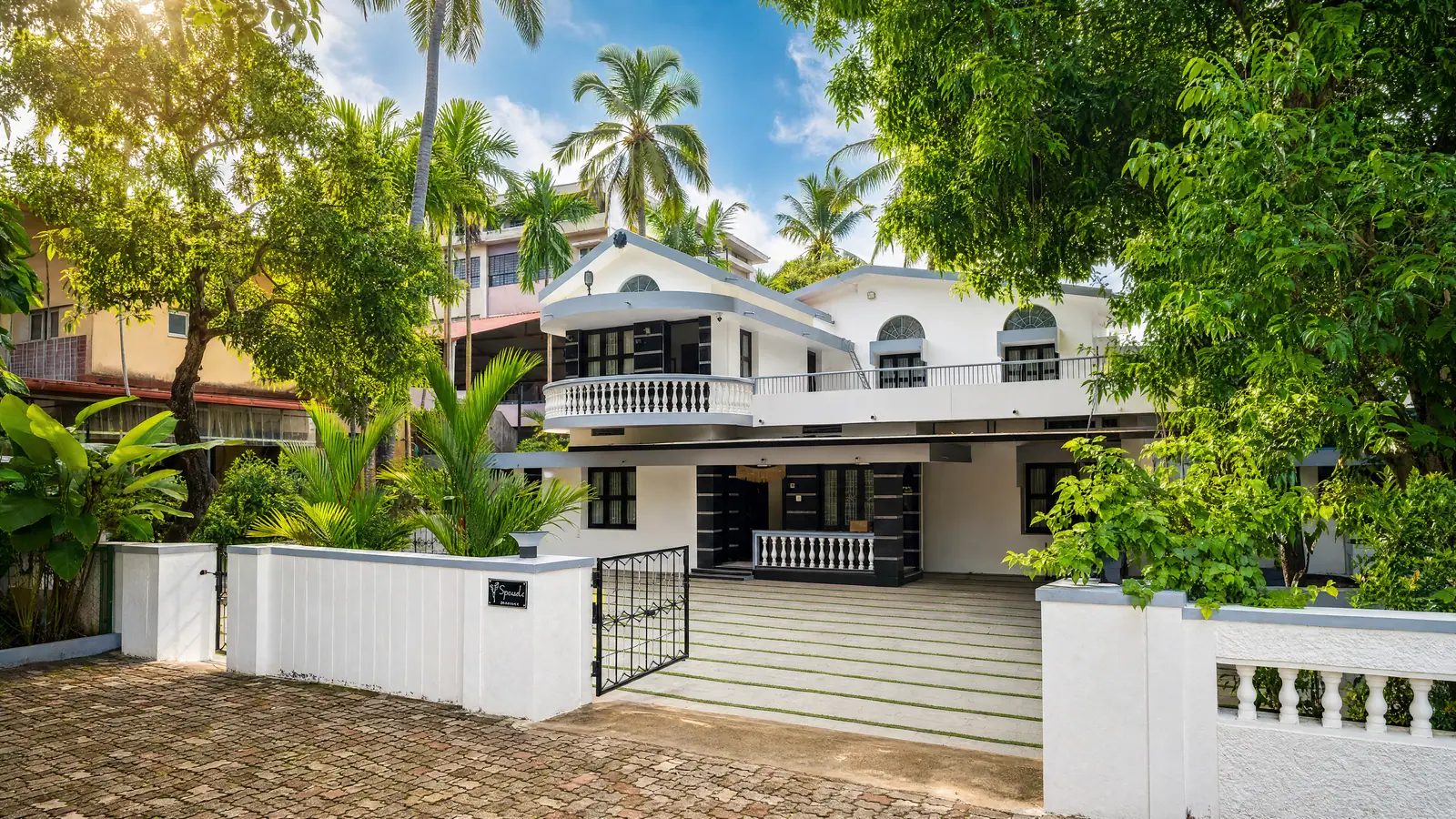Spanda Homestay — the white heritage house framed by old palms in the heart of Udupi